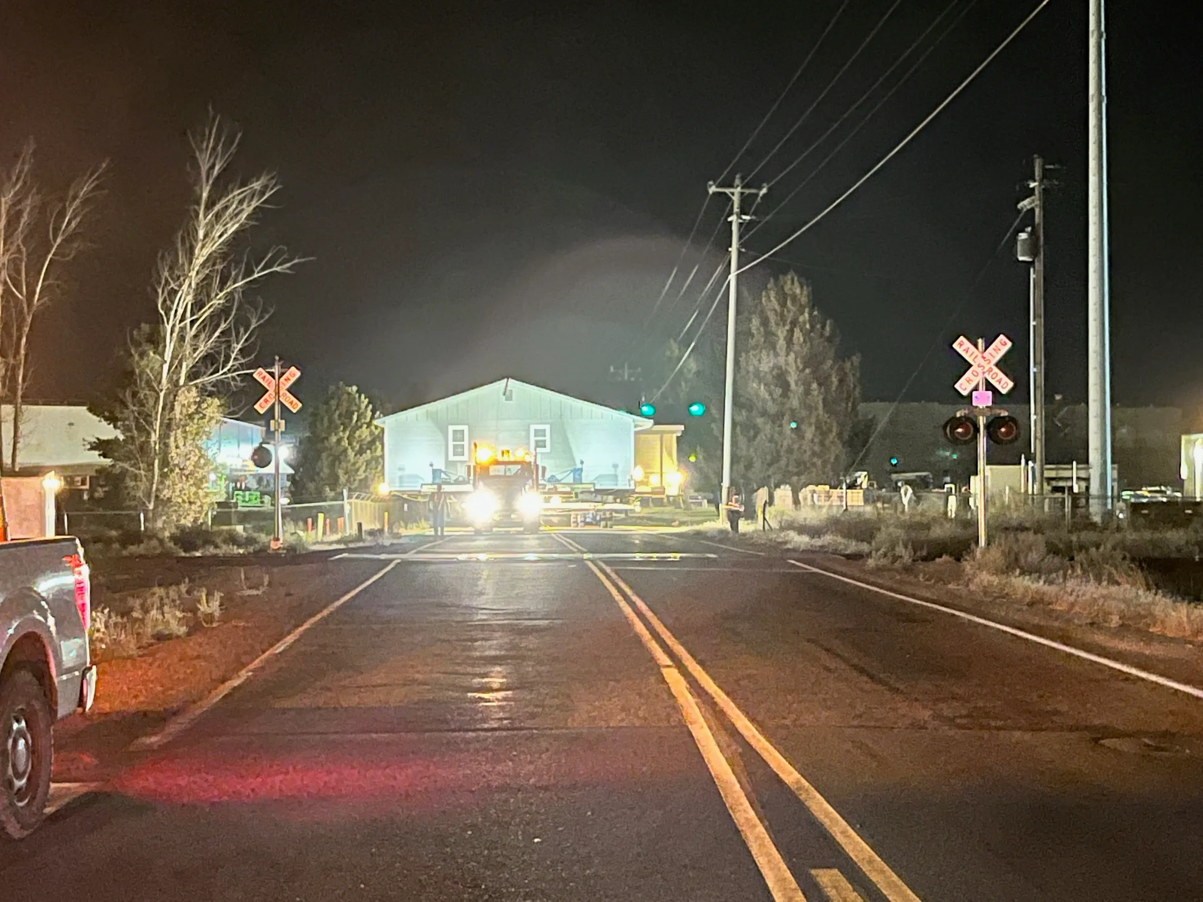The house approaching a railroad crossing at night