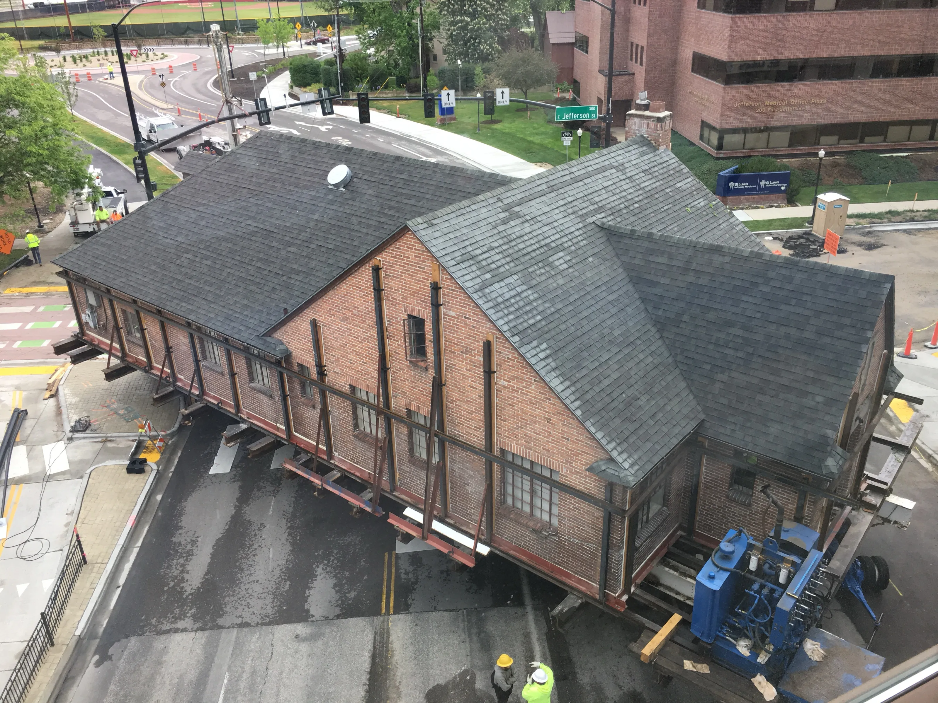 Aerial view of a brick building crossing a city intersection on hydraulic dollies