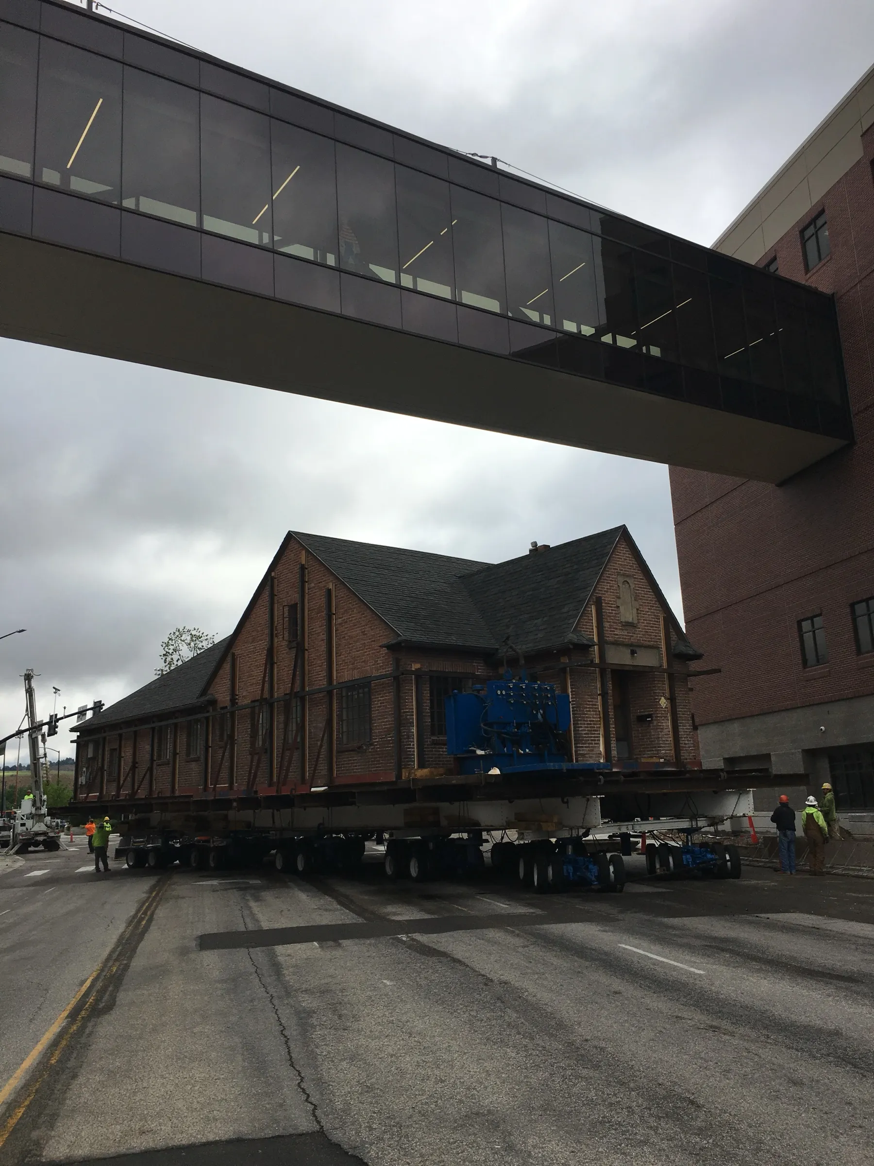 The building passing beneath a glass skybridge