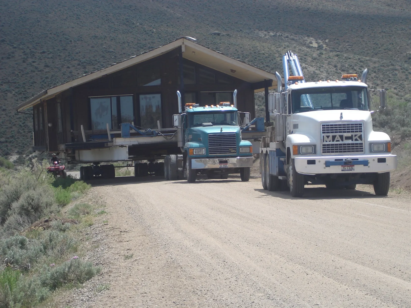 House and Mack truck on a gravel road
