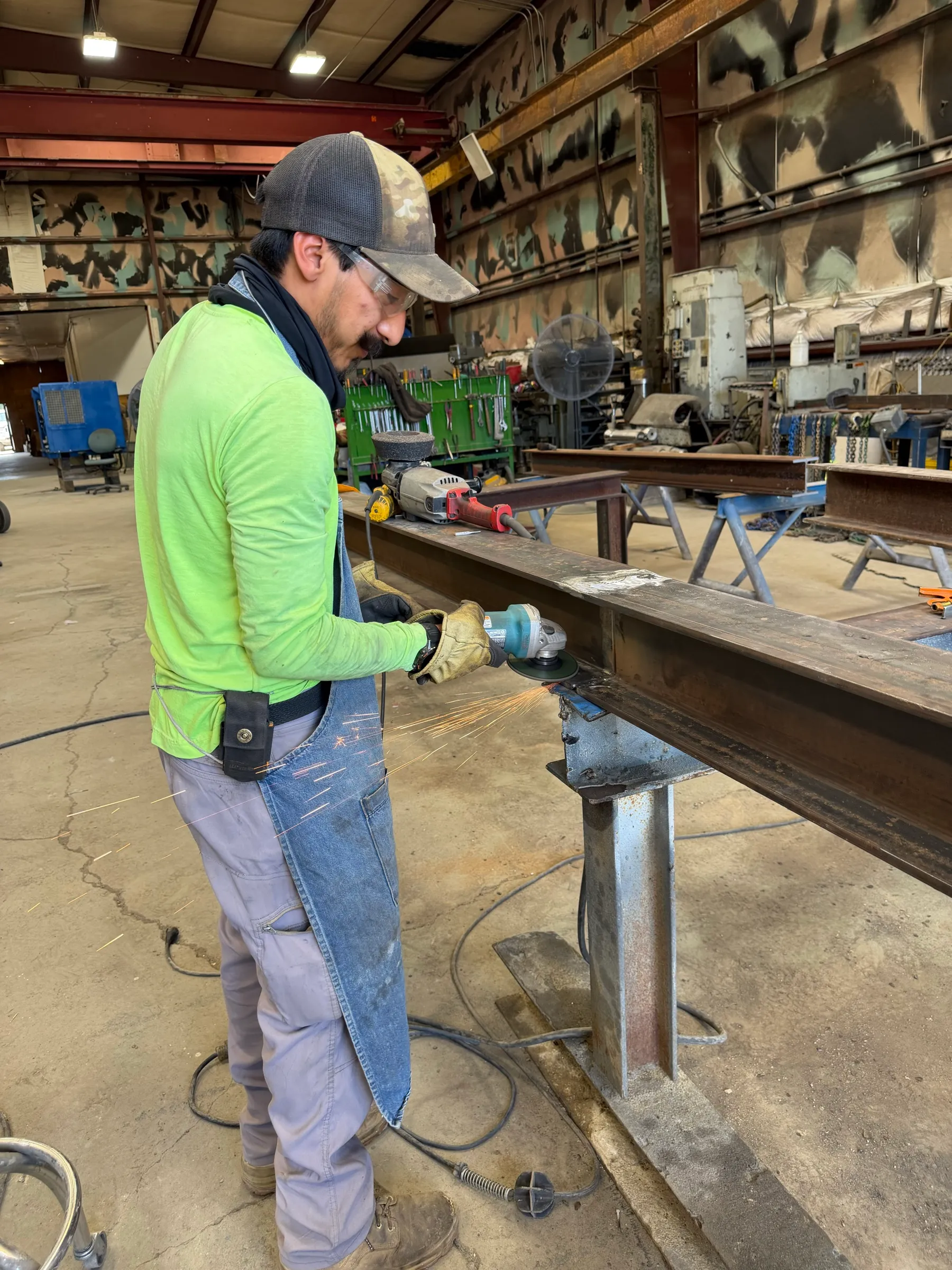 Fitting and grinding a structural steel I-beam in the shop