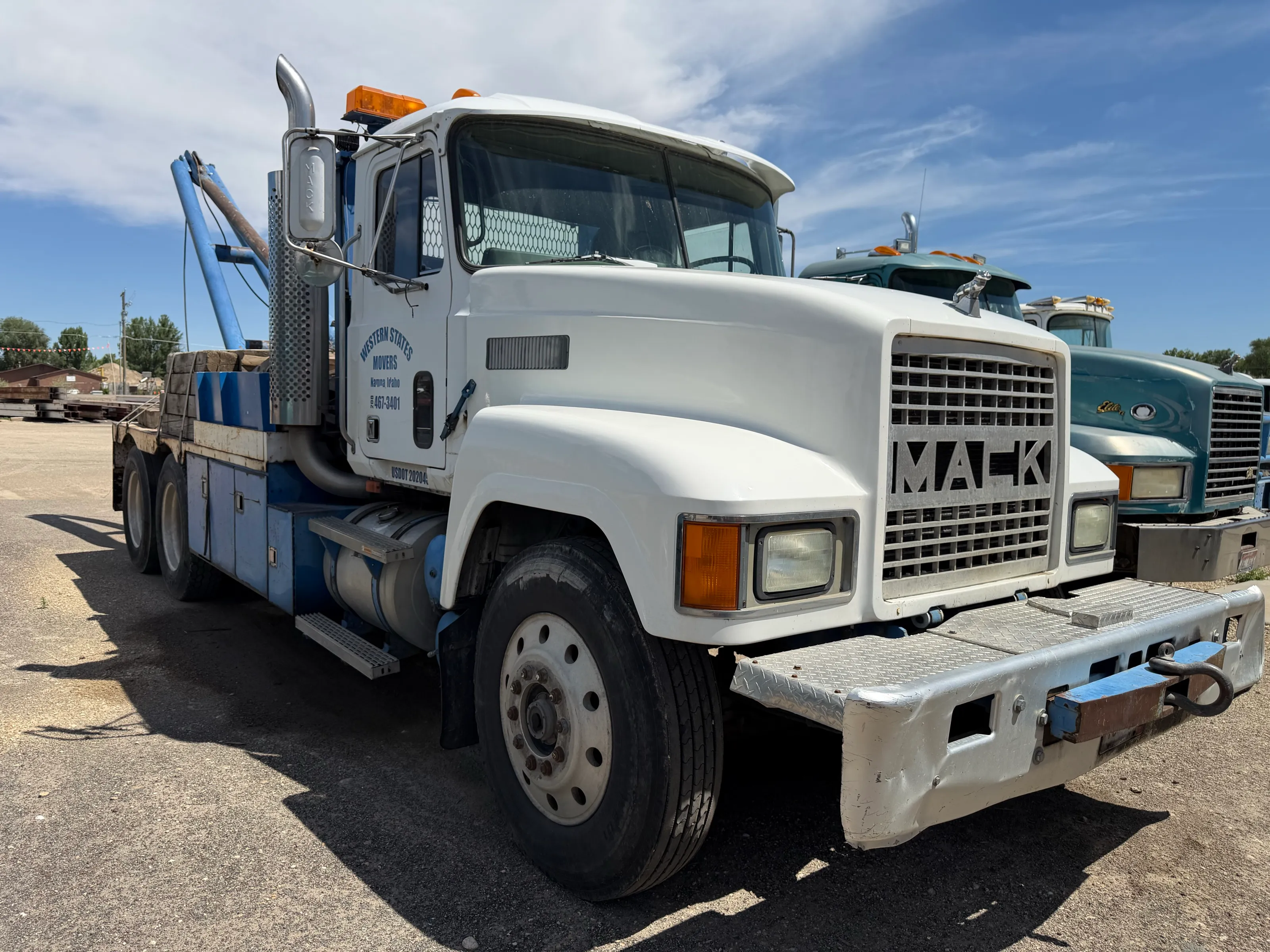 The white Western States Mack crane truck in the yard