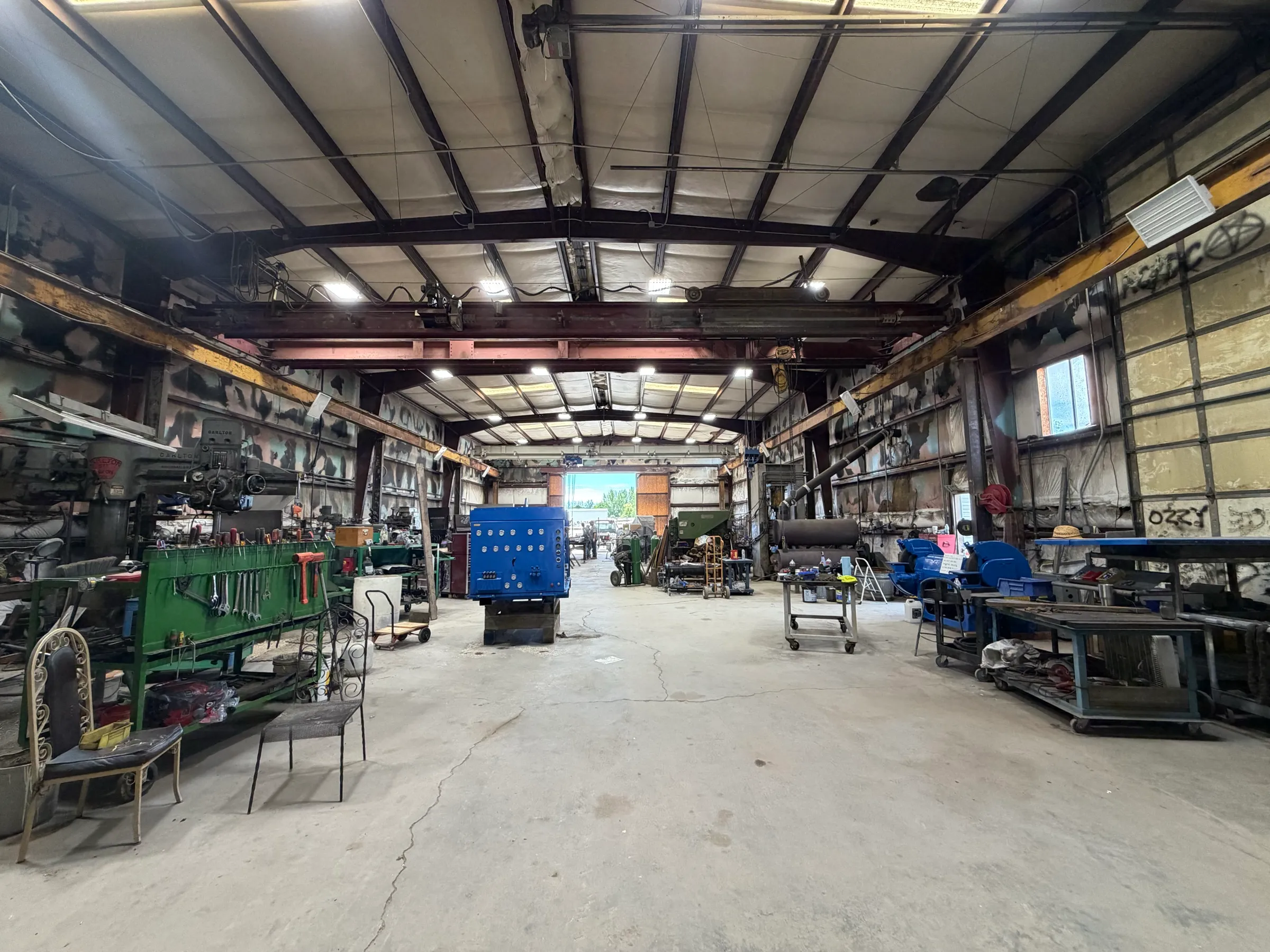 Wide view down the fabrication shop bay with overhead crane rail