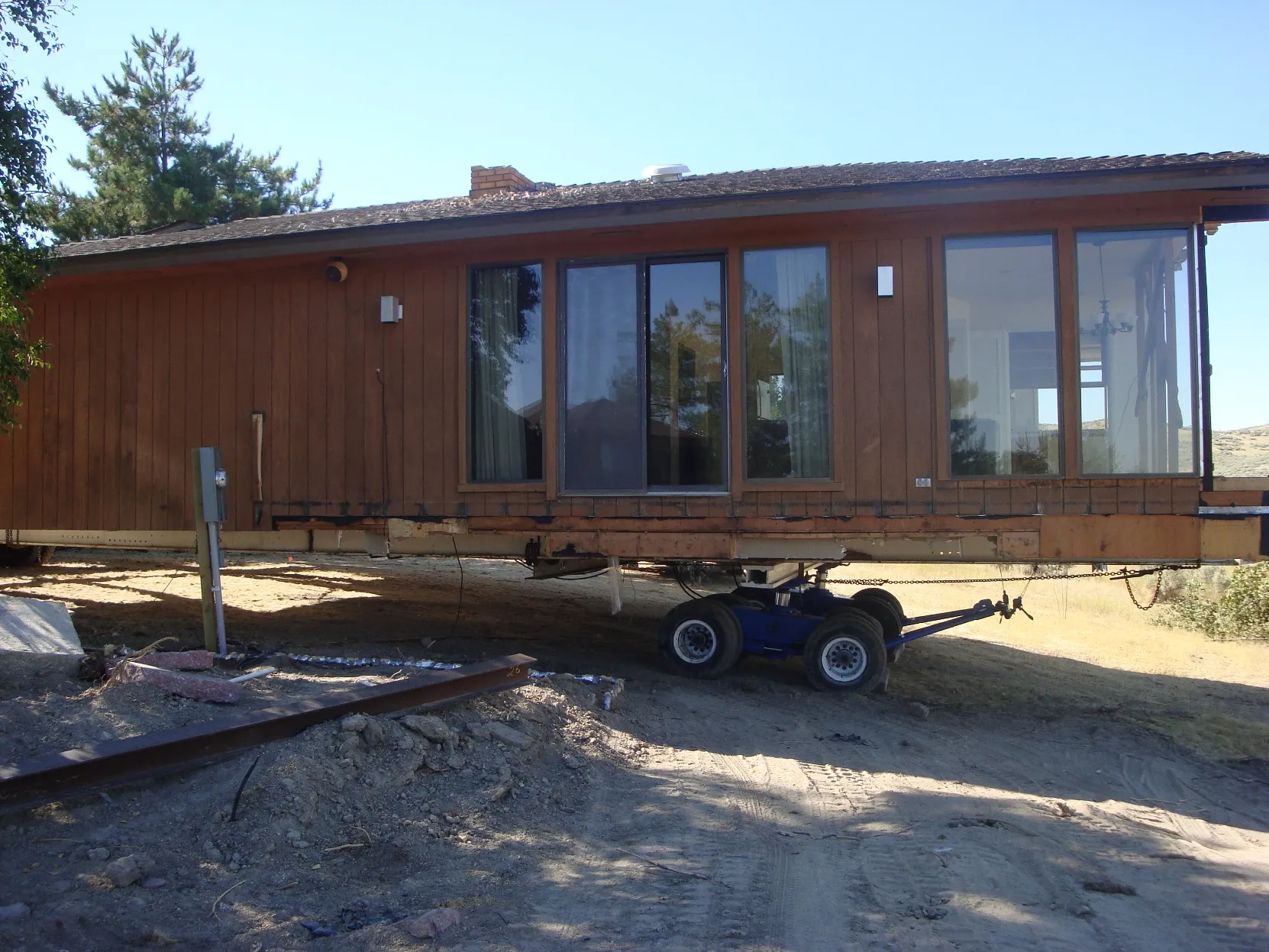 Cedar house on a hydraulic trailer during a move