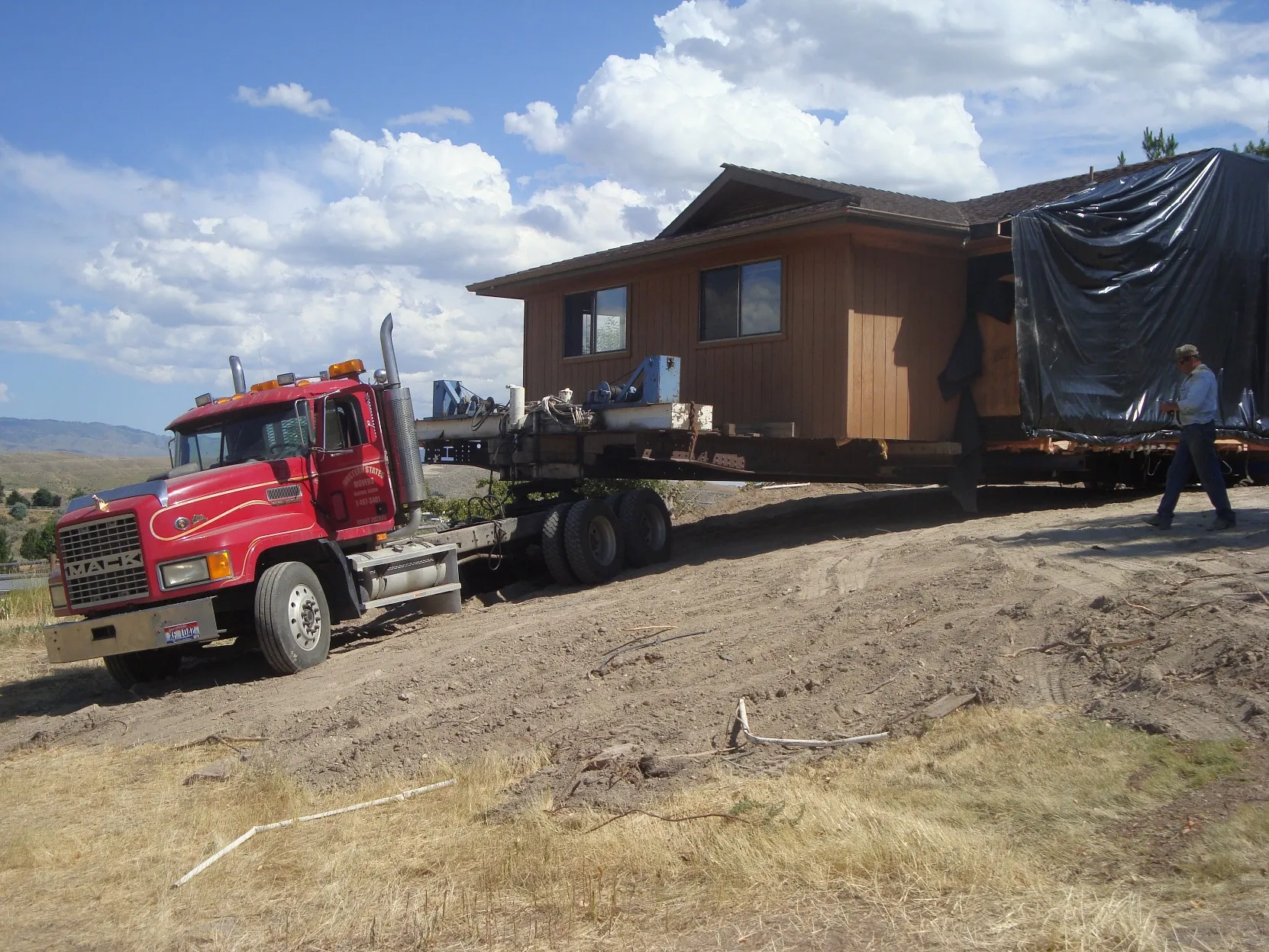 House and truck cresting a slope