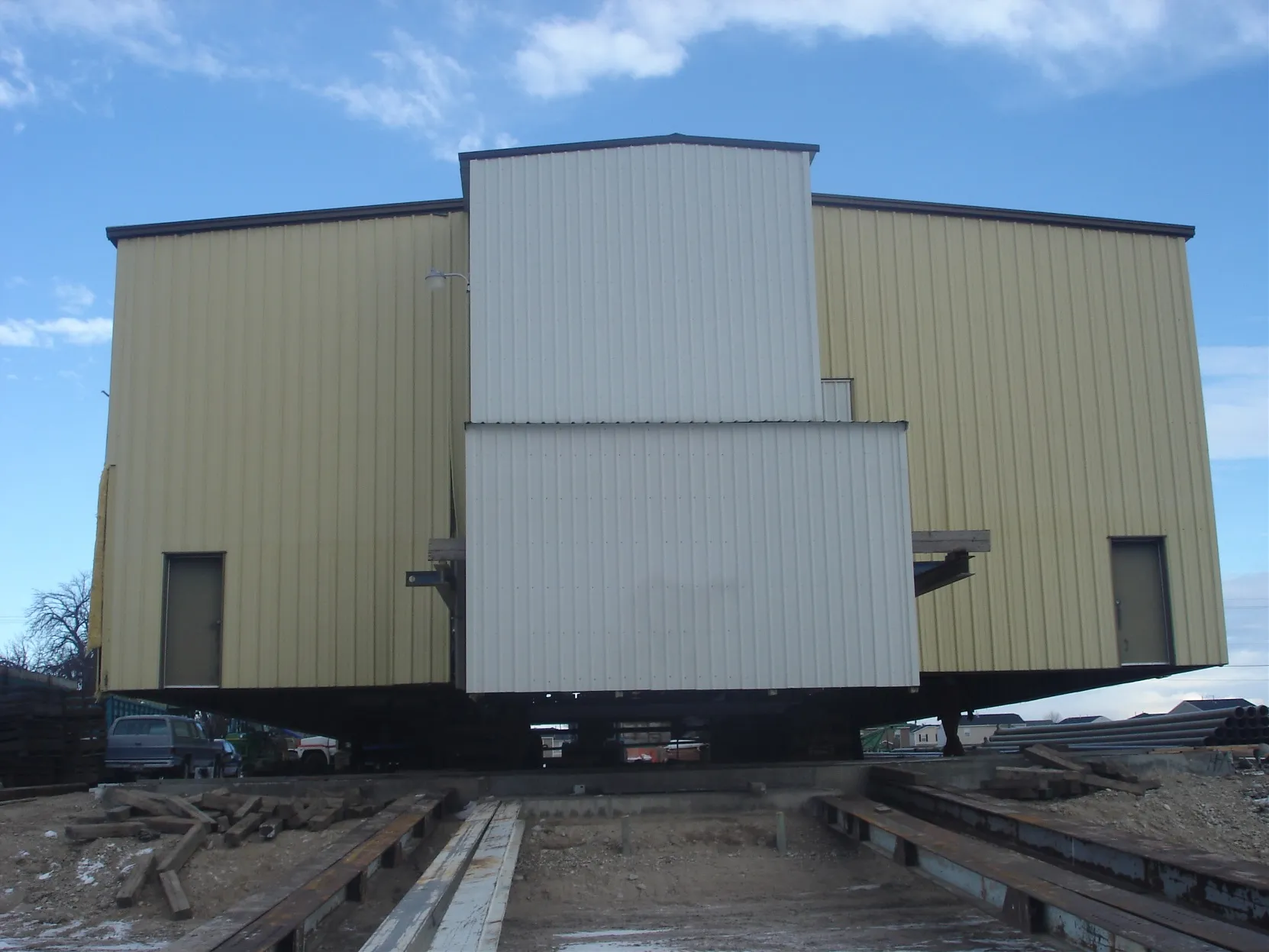 Large metal shop building being moved in snow