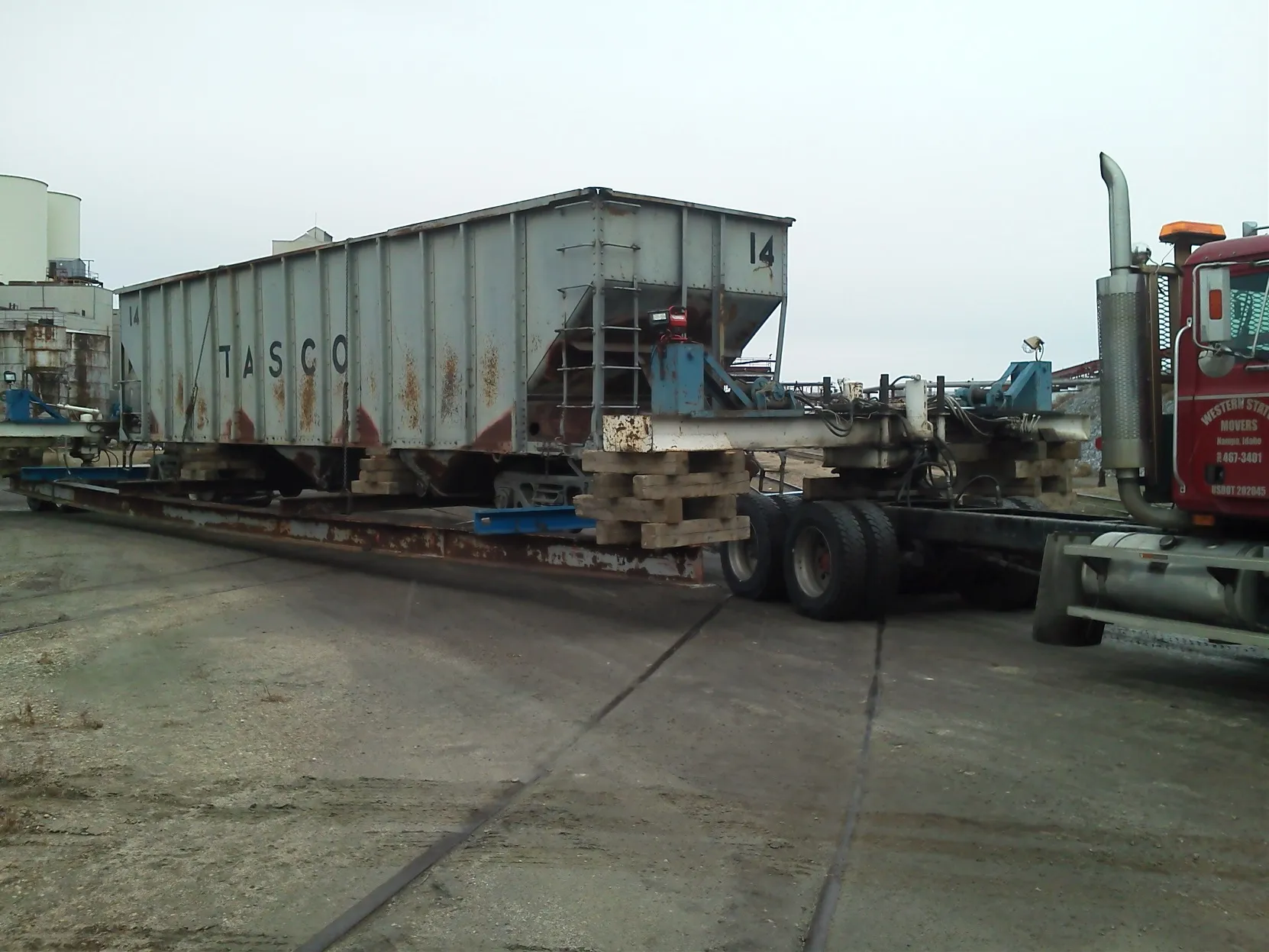 Grain hopper railcar on a trailer